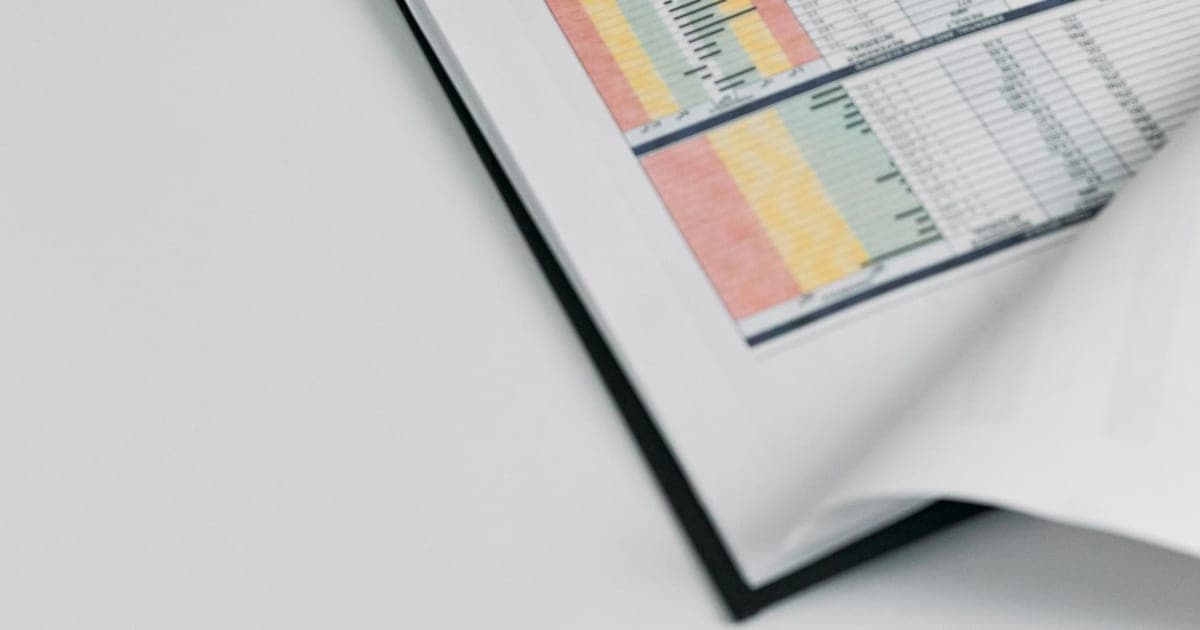 Doctor reviewing a medical chart on a desk.