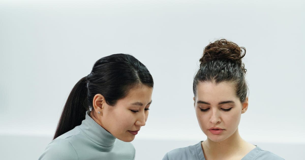 Clinician reviewing information on a tablet with a patient.