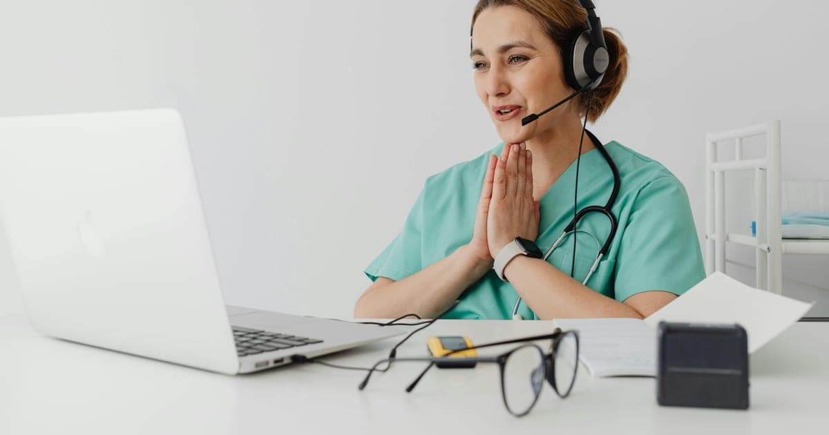 Doctor on a telehealth consultation at a laptop.