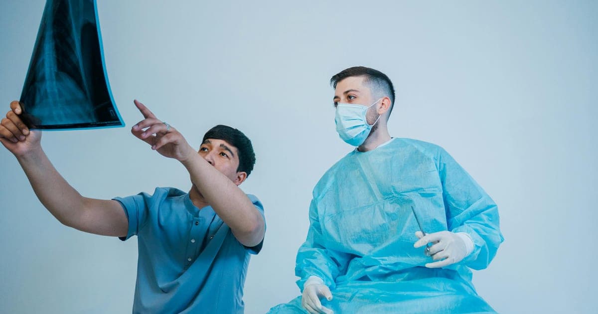 Medical workers reviewing an X-ray before a procedure.